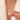 Woman holding a peridot baguette silver ring delicately between two fingertips.