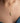 The woman has a heart necklace around her neck.
