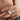 The woman is wearing a silver sun necklace and is holding the pendant on her fingers. A photo of the necklace open showing the text engraved inside is also included.