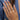 gold, silver and rose gold tone sterling silver Hamsa hand rings worn on a woman&#39;s fingers.
