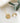 On a white cloth, there is a gold necklace and an engravable pendant. On both sides of the cloth, there are small green branches.  A photo of the necklace open, showing the text engraved inside, is also added.