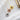 Rose gold, gold and silver necklaces are lined up on a white cloth