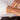 The woman has three bracelets in gold, rose gold and silver on her right arm.