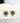 There are 2 round emerald earrings on a white background. There are white zircon stones around the emerald.
