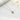 Ruby red birthstone necklace with a halo setting displayed on soft white fabric – shimmering and vibrant pendant centerpiece.