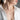 Woman wearing an emerald halo necklace over a white open-collar shirt – elegant and minimal look for everyday style.